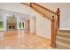 Grand staircase with ornate wood detailing and terracotta flooring at 12151 Walker Pond Rd, Winter Garden, FL 34787