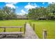 Wooden dock provides access to the tranquil pond, near the house at 12151 Walker Pond Rd, Winter Garden, FL 34787