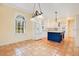 Kitchen features white cabinets, a blue island, and terracotta tile floor at 12151 Walker Pond Rd, Winter Garden, FL 34787