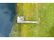 Aerial view of a long dock extending from the lakeshore at 12151 Walker Pond Rd, Winter Garden, FL 34787