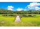 Peaceful pond with a wooden dock, offering a picturesque view at 12151 Walker Pond Rd, Winter Garden, FL 34787