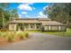 Two-story home with circular driveway and landscaping at 12151 Walker Pond Rd, Winter Garden, FL 34787