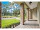 Brick pillars and wood flooring create a charming porch overlooking the grounds at 12151 Walker Pond Rd, Winter Garden, FL 34787