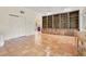Spacious living room featuring built-in shelving and terracotta tile floors at 12151 Walker Pond Rd, Winter Garden, FL 34787