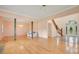 Open concept living area with hardwood floors and a view to the entryway at 12151 Walker Pond Rd, Winter Garden, FL 34787