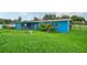 View of blue house from grassy yard at 3034 Touraine Ave, Orlando, FL 32812