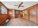 Living room with wood paneled walls, wood flooring and ceiling fan at 3034 Touraine Ave, Orlando, FL 32812