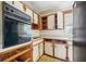 Kitchen with wood cabinets, appliances, and tiled floor at 3034 Touraine Ave, Orlando, FL 32812