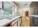 Kitchen with wood cabinets, double sink, and tiled floor at 3034 Touraine Ave, Orlando, FL 32812