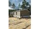 Exterior view of a manufactured home under partly cloudy skies at 17697 Sw 40Th St, Dunnellon, FL 34432