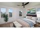 Spacious bedroom with hardwood floors, large windows, and ceiling fan at 1987 Peel Ave, Orlando, FL 32806