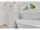 Modern bathroom with a walk-in shower, soaking tub, and marble tile at 2620 Osceola Bluff Ln, Geneva, FL 32732