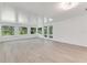 Bright Gathering room featuring wood-look tile floors and sliding glass doors at 2620 Osceola Bluff Ln, Geneva, FL 32732