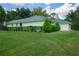 House exterior showcasing a metal roof and landscaping at 2620 Osceola Bluff Ln, Geneva, FL 32732