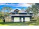 Two-car garage with extra storage space and a large deck at 2620 Osceola Bluff Ln, Geneva, FL 32732