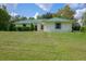 Single-story home with green metal roof and lush lawn at 2620 Osceola Bluff Ln, Geneva, FL 32732