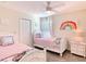 Fun bedroom with twin beds and rainbow wall art at 345 Ocean Course Ave, Davenport, FL 33896