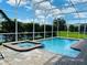 Relaxing pool and spa with screened enclosure at 345 Ocean Course Ave, Davenport, FL 33896