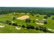 Aerial view of community golf course with lush green fairways and sand traps at 345 Ocean Course Ave, Davenport, FL 33896