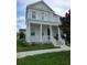 Two-story house with white columns and balcony at 7410 Barrier Cove Way, Kissimmee, FL 34747