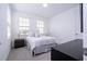 Spacious bedroom featuring a queen bed and plenty of natural light at 7410 Barrier Cove Way, Kissimmee, FL 34747