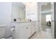 Double vanity bathroom with modern finishes and a view into a home office at 7410 Barrier Cove Way, Kissimmee, FL 34747