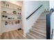 Modern stairwell with built-in shelving and wood-look flooring at 7410 Barrier Cove Way, Kissimmee, FL 34747
