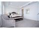 Spacious main bedroom with a king bed, sitting chair and access to the bathroom at 7410 Barrier Cove Way, Kissimmee, FL 34747