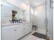 Modern bathroom with double vanity, walk-in shower, and marble tile at 7410 Barrier Cove Way, Kissimmee, FL 34747