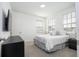 Bright bedroom with a queen bed, ample natural light, and modern nightstands at 7410 Barrier Cove Way, Kissimmee, FL 34747
