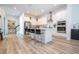 Modern kitchen boasts white cabinets, stainless steel appliances, and an island with seating at 7410 Barrier Cove Way, Kissimmee, FL 34747