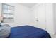 Bright bedroom with a full-size bed and double door closet at 7410 Barrier Cove Way, Kissimmee, FL 34747