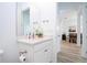 Clean bathroom with a vanity and view of the dining area at 7410 Barrier Cove Way, Kissimmee, FL 34747
