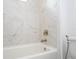 Bathroom with modern bathtub and marble tile surround at 7410 Barrier Cove Way, Kissimmee, FL 34747