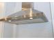 Stainless steel range hood with integrated lighting at 7410 Barrier Cove Way, Kissimmee, FL 34747