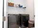 Well-equipped laundry room with washer, dryer, and shelving at 7410 Barrier Cove Way, Kissimmee, FL 34747