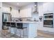 Modern kitchen with white cabinets, stainless steel appliances, and an island at 7410 Barrier Cove Way, Kissimmee, FL 34747