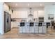 Modern kitchen with white cabinets, stainless steel appliances and island at 7410 Barrier Cove Way, Kissimmee, FL 34747