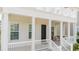 Front porch with black door and white columns at 7410 Barrier Cove Way, Kissimmee, FL 34747
