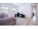 Bright home office featuring a desk, chair, and comfortable couch at 7410 Barrier Cove Way, Kissimmee, FL 34747