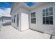 Balcony with door access and white exterior walls at 7410 Barrier Cove Way, Kissimmee, FL 34747