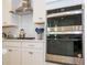 Stainless steel appliances and white shaker cabinets in this bright kitchen at 7410 Barrier Cove Way, Kissimmee, FL 34747