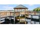 Lakeside gazebo and dock with seating for relaxation at 13415 Blue Heron Beach Dr # 708, Orlando, FL 32821