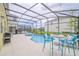 Enclosed pool and patio area with seating, grill, and string lights at 4498 Monado Dr, Kissimmee, FL 34746