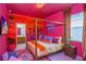 A themed bedroom with a large bed, colorful decor, and a mural at 4498 Monado Dr, Kissimmee, FL 34746