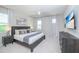 Main bedroom with a king-size bed and modern gray accents at 4498 Monado Dr, Kissimmee, FL 34746