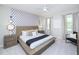 Main bedroom with large bed, stylish decor, and plenty of light at 4498 Monado Dr, Kissimmee, FL 34746