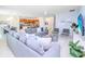 Open-concept living room with sectional sofa and views into kitchen and dining areas at 4498 Monado Dr, Kissimmee, FL 34746