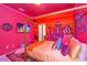 A themed bedroom with a large bed, colorful decor, and a mural at 4498 Monado Dr, Kissimmee, FL 34746