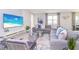 Spacious living room featuring a large sectional sofa, stylish coffee tables, and a large TV at 4498 Monado Dr, Kissimmee, FL 34746